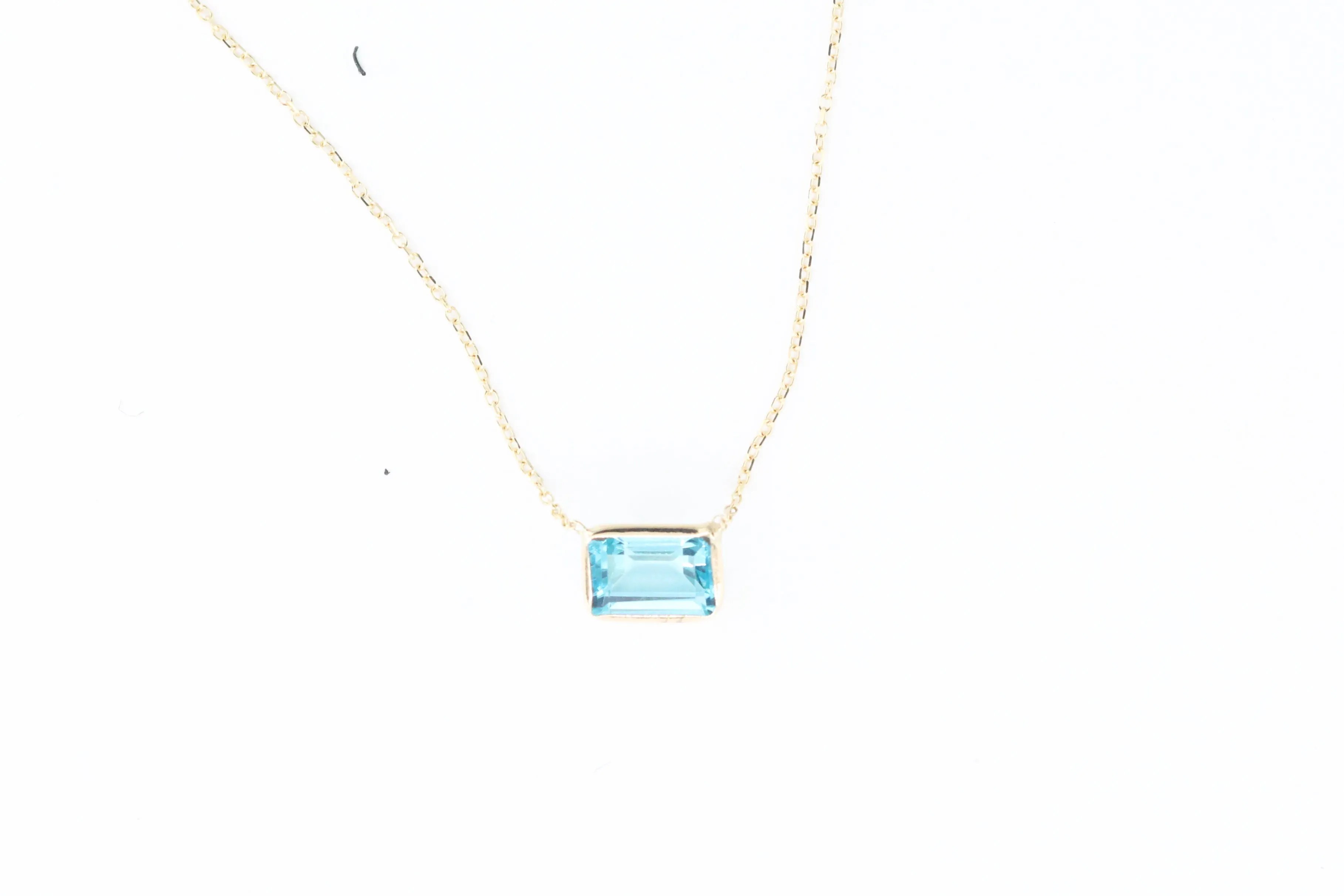 Yellow Gold Emerald Cut Bezel Set Blue Topaz Necklace